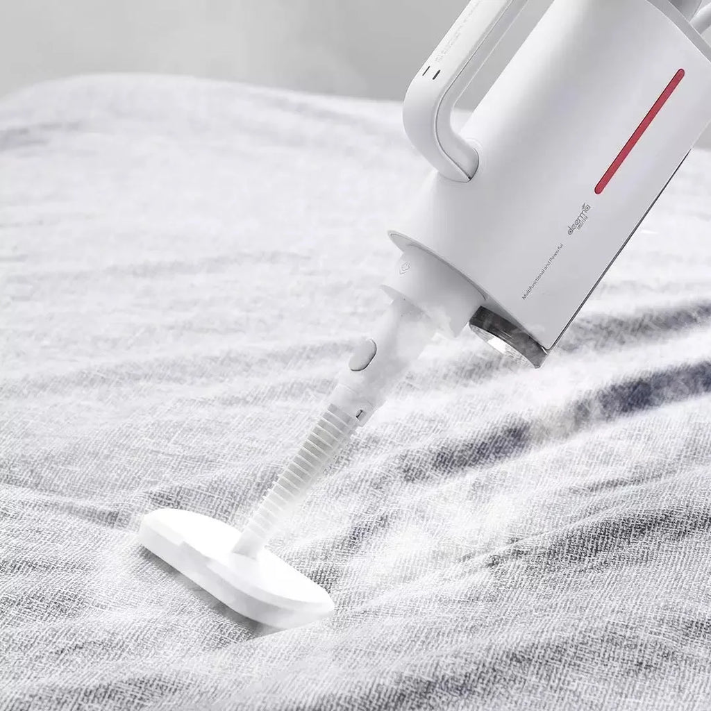 White Deerma ZQ610 steam cleaner main unit with five brush heads and connecting tubes laid out.