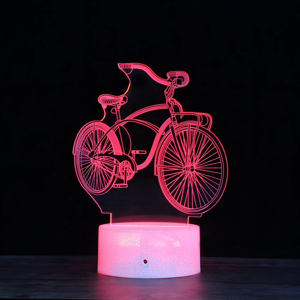 3D bicycle LED night light with acrylic shade and black base on a desk