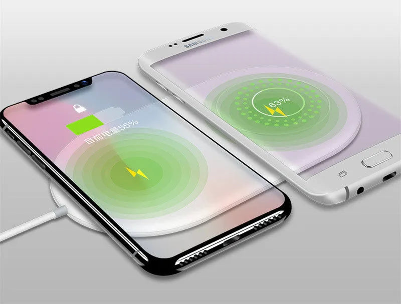 Simple white wireless charging pad showing two mobile phones charging simultaneously on its surface.