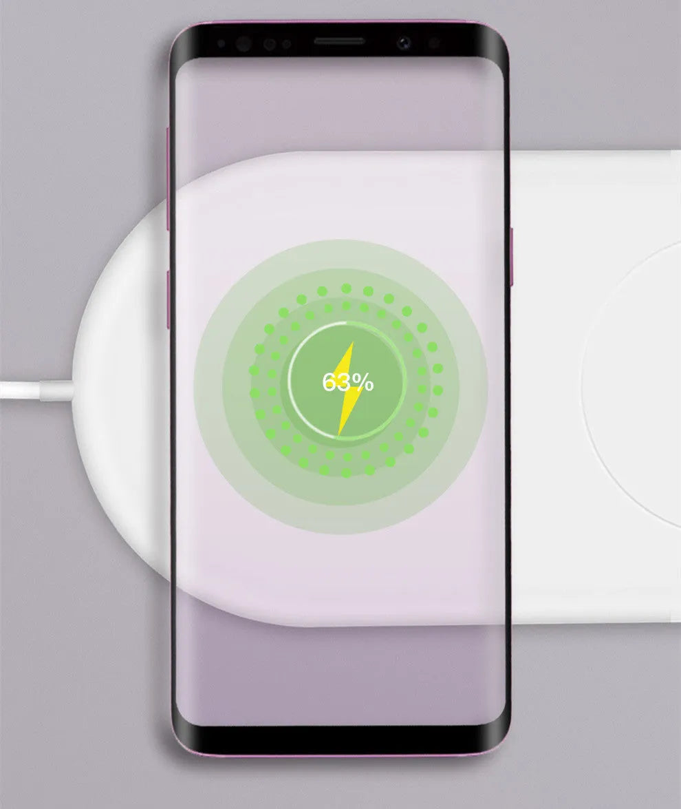 Simple white wireless charging pad showing two mobile phones charging simultaneously on its surface.