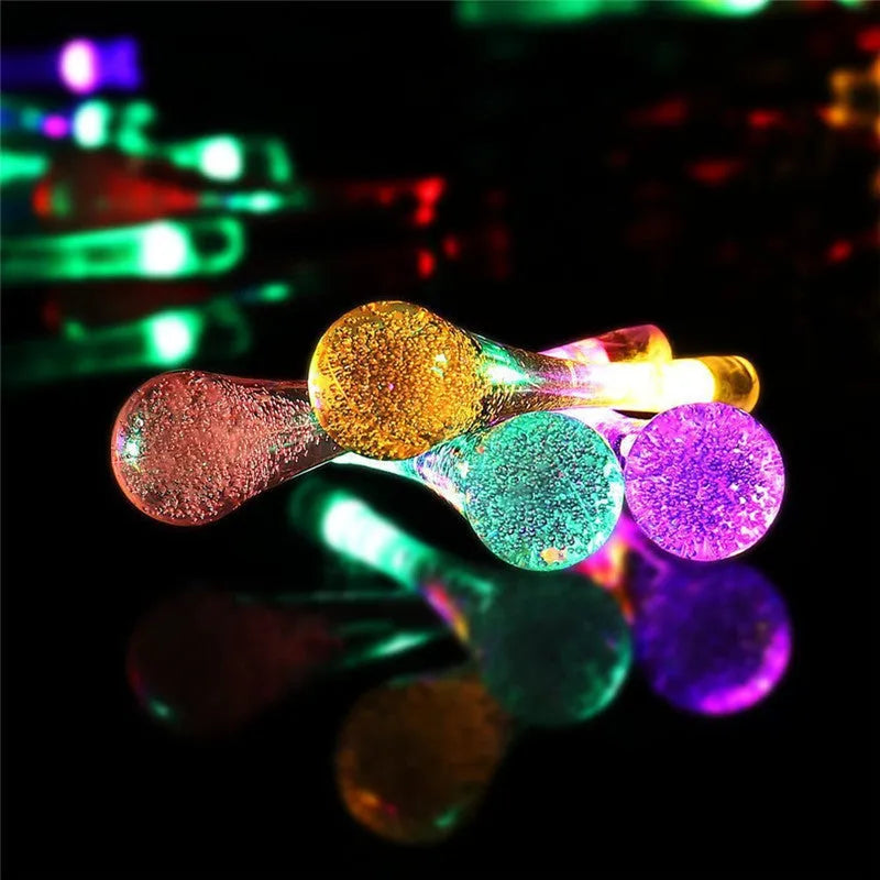 Solar LED string lights with bubble drop pendants for outdoor garden decoration