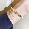 Women's pink freshwater pearl bracelet with geometric design and strawberry crystal charms