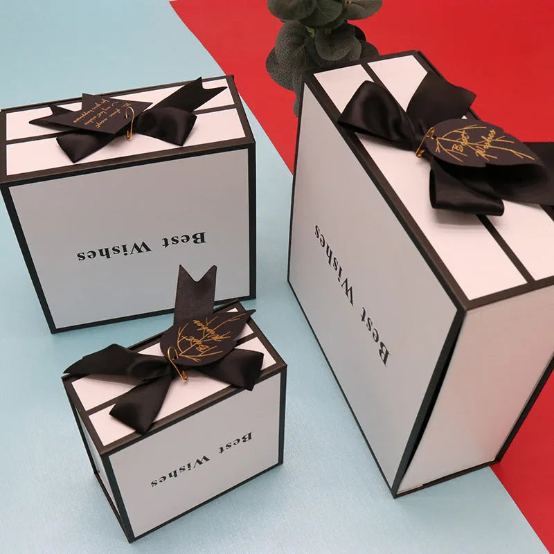 White square clamshell book gift box for lipstick cosmetics, 12x12x6cm size with lid open, on plain background