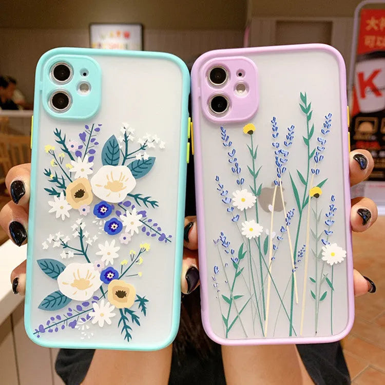 iPhone case with blue flower cartoon design and contrasting pink matte frame on a mobile phone.