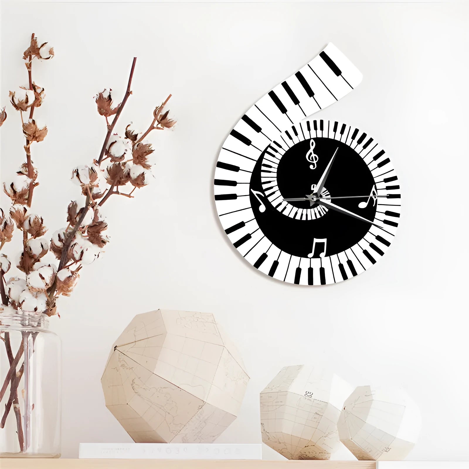 Irregular shaped wall clock with treble clef, piano keyboard and musical note design elements in black and white