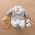 Baby boy wearing a long-sleeved cotton gentleman's style romper in a classic collared design.