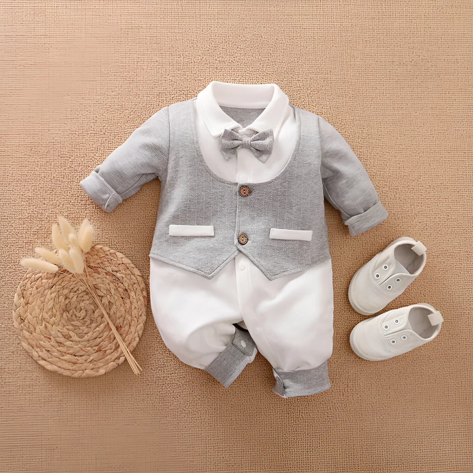 Baby boy wearing a long-sleeved cotton gentleman's style romper in a classic collared design.