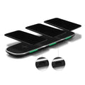 Black Qi wireless charging pad on desk charging smartphone