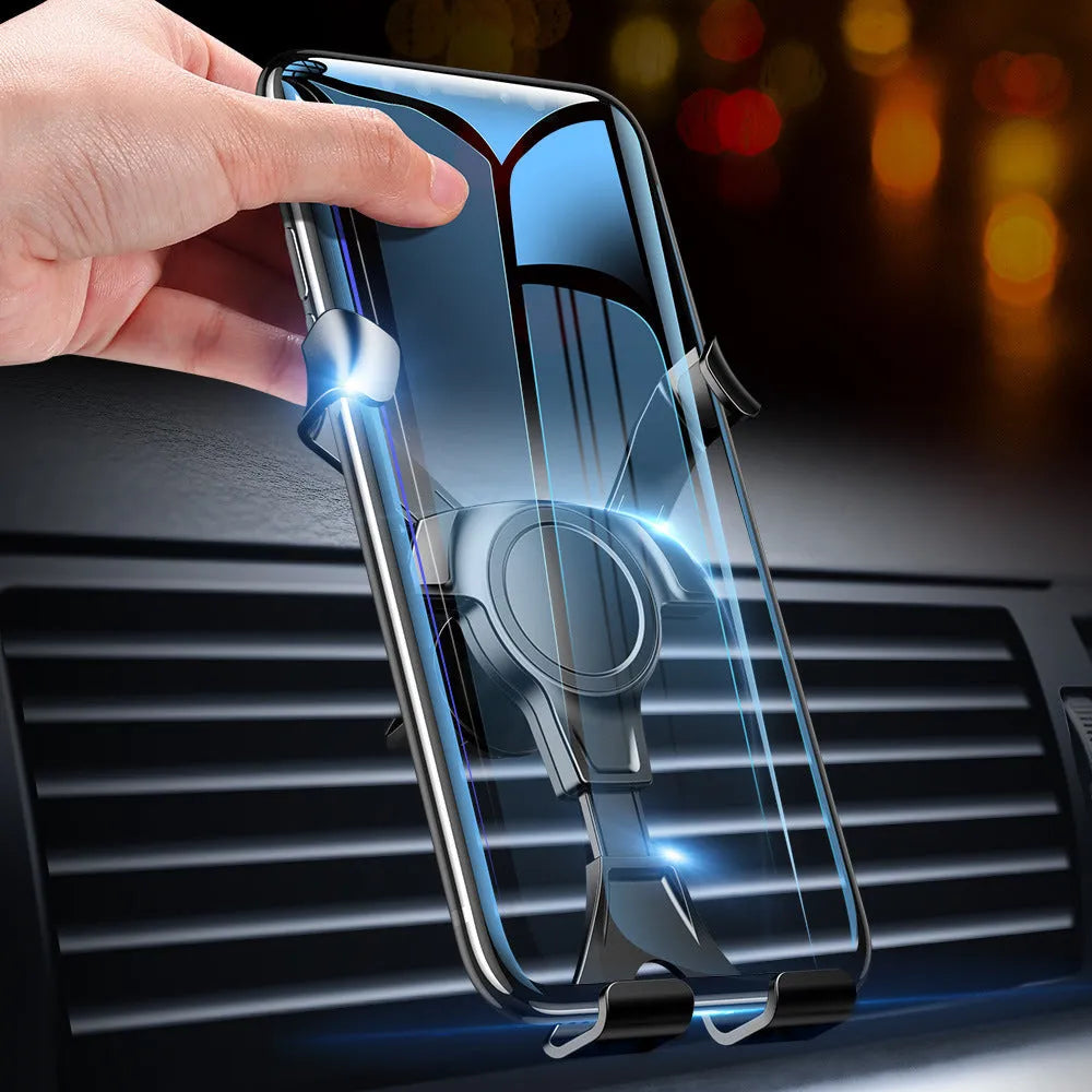 Black plastic car phone holder clipped to a car air vent with a smartphone inserted