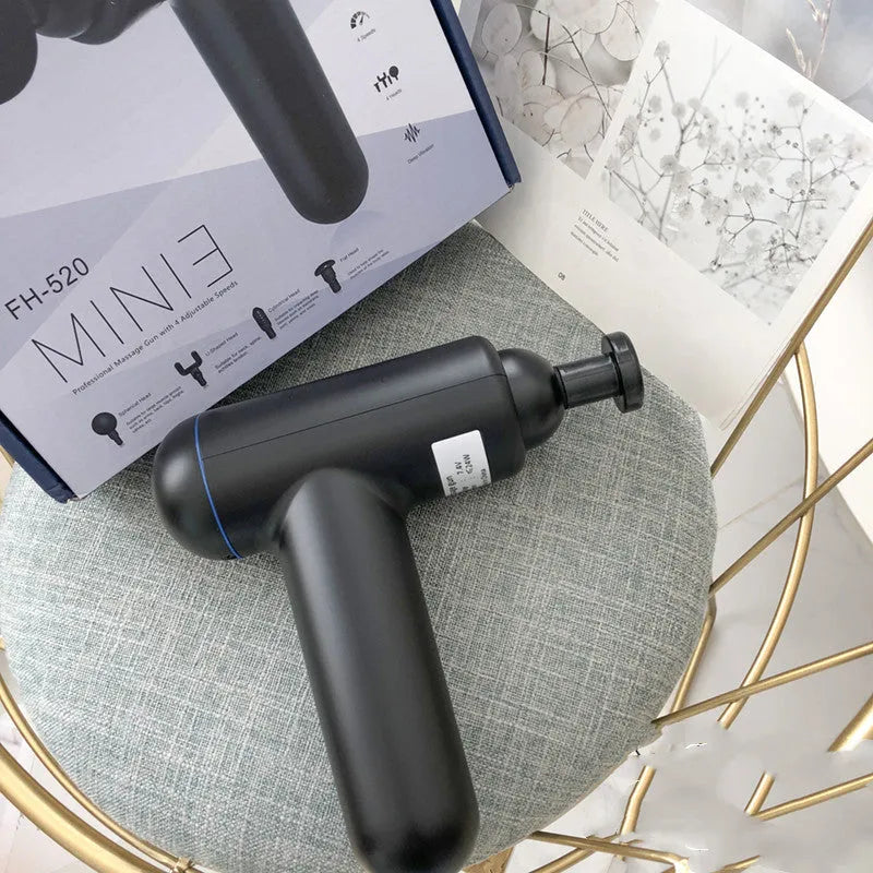 Black USB fascia gun massager for muscle relaxation on a grey background.