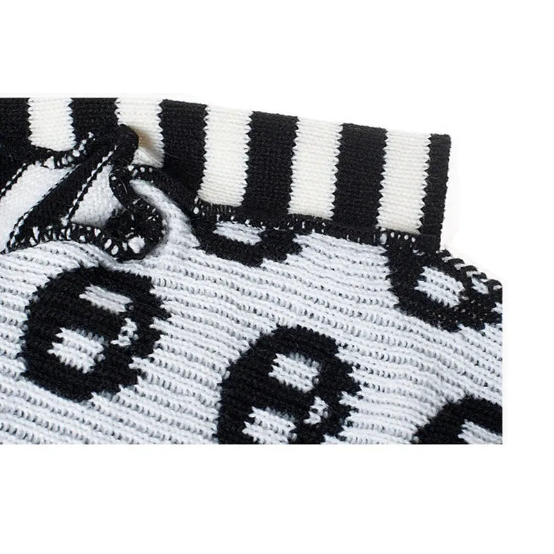 Black acrylic skull-patterned dog Halloween sweater on a small dog, sizes XXS to XL available