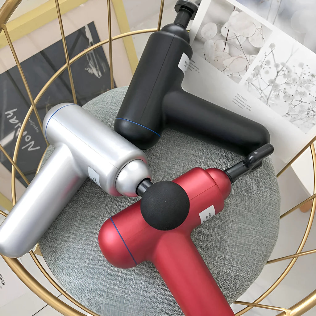 Black USB fascia gun massager for muscle relaxation on a grey background.