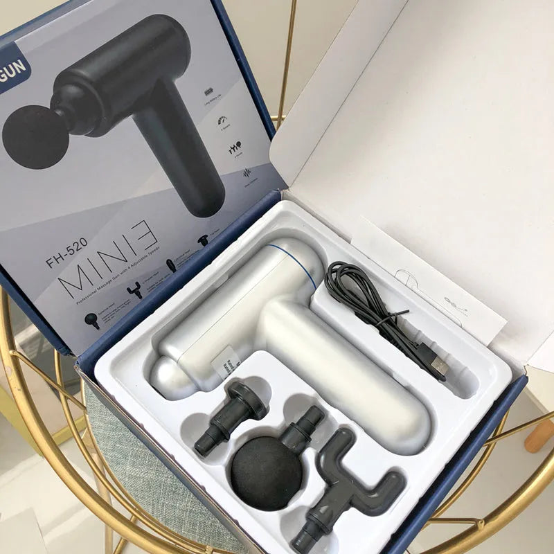 Black USB fascia gun massager for muscle relaxation on a grey background.