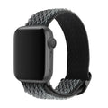 Braided nylon elastic strap for Apple Watch in wave pattern, showing adjustable fit on wrist.