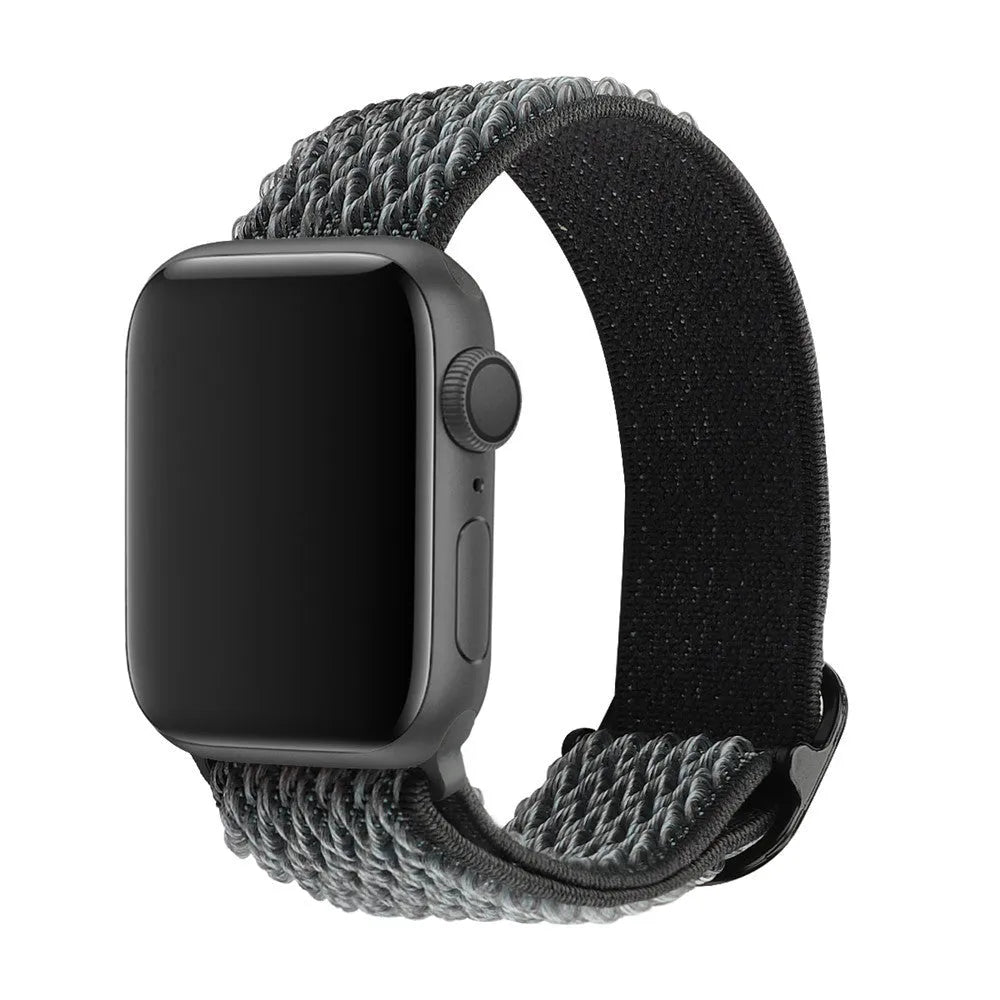 Braided nylon elastic strap for Apple Watch in wave pattern, showing adjustable fit on wrist.