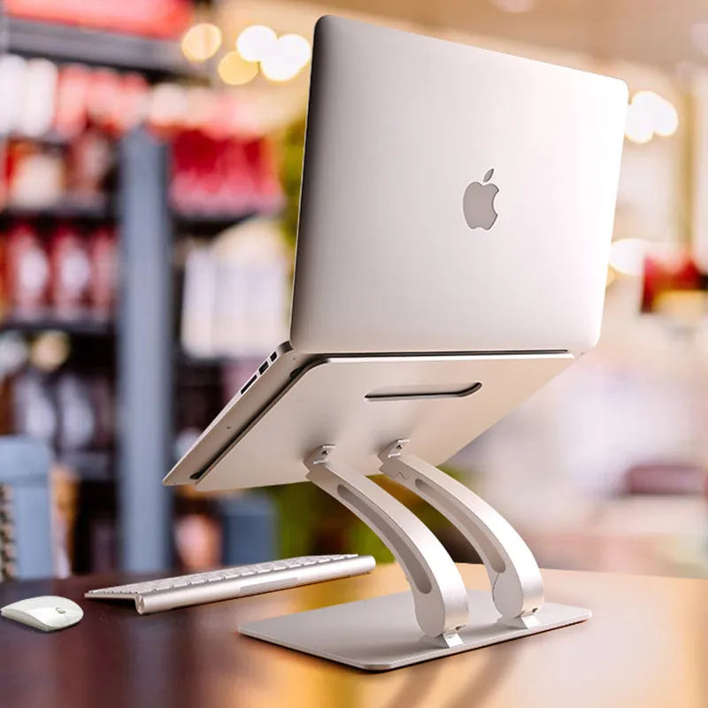 Folding aluminium alloy laptop and tablet stand on a desk, shown in black colour with a laptop placed on top.
