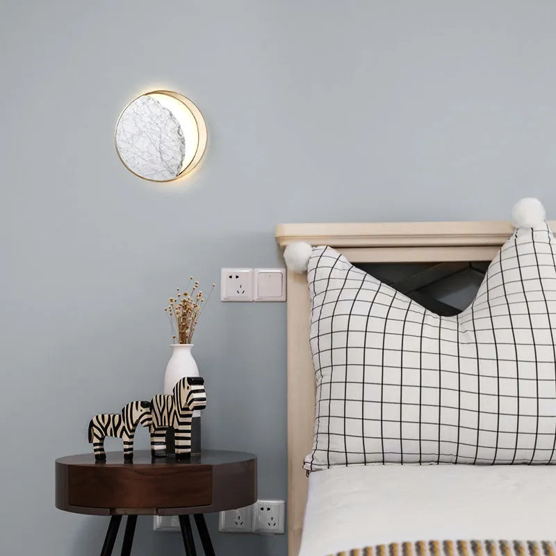 Round marble and copper eclipse art design LED wall lamp with a diameter of 25cm.