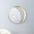 Round marble and copper eclipse art design LED wall lamp with a diameter of 25cm.