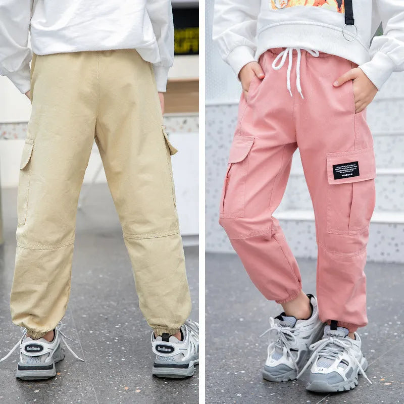 Children's cotton workwear trousers in black, khaki, or pink, sizes 110-160cm, with elastic waist and plus-velvet options.