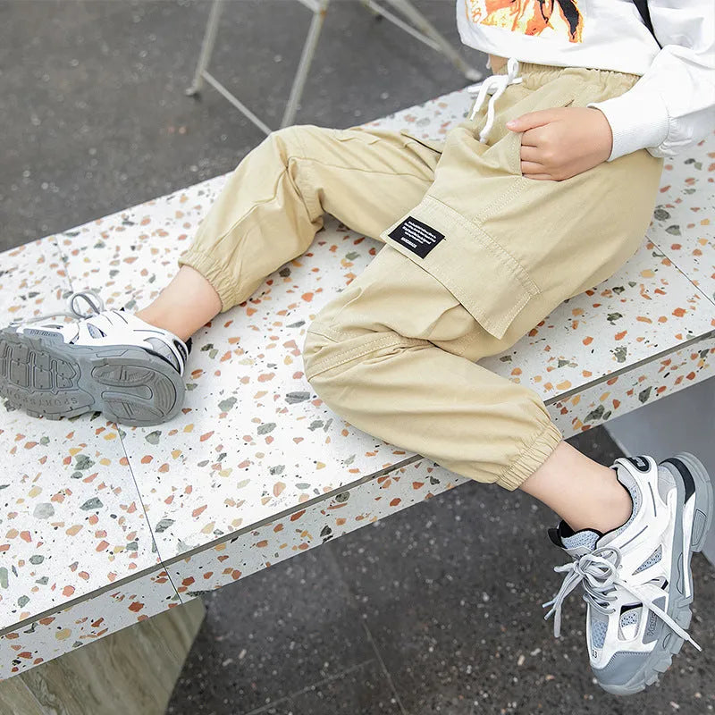 Children's cotton workwear trousers in black, khaki, or pink, sizes 110-160cm, with elastic waist and plus-velvet options.