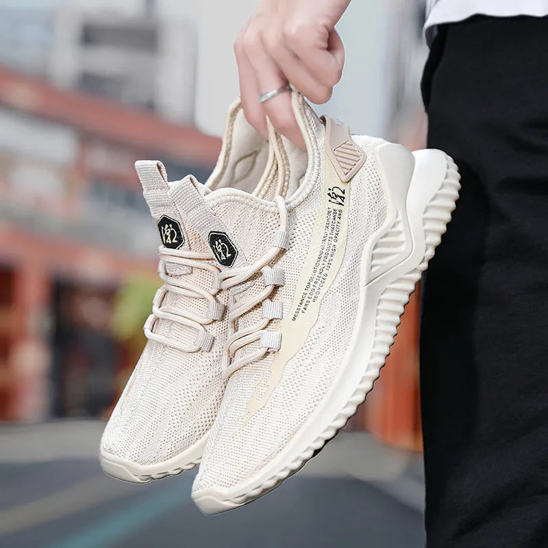 Men's low-top white mesh sports shoes with black rubber sole on a plain background