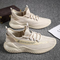 Men's low-top white mesh sports shoes with black rubber sole on a plain background