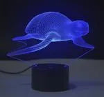 Colourful 3D LED table lamp with touch control and remote on a desk