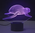 Colourful 3D LED table lamp with touch control and remote on a desk