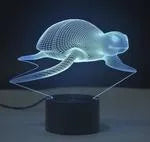 Colourful 3D LED table lamp with touch control and remote on a desk