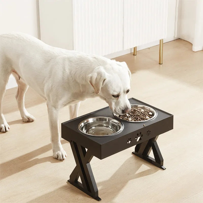 Black folding pet bowl with stainless steel interior and plastic outer shell on surface