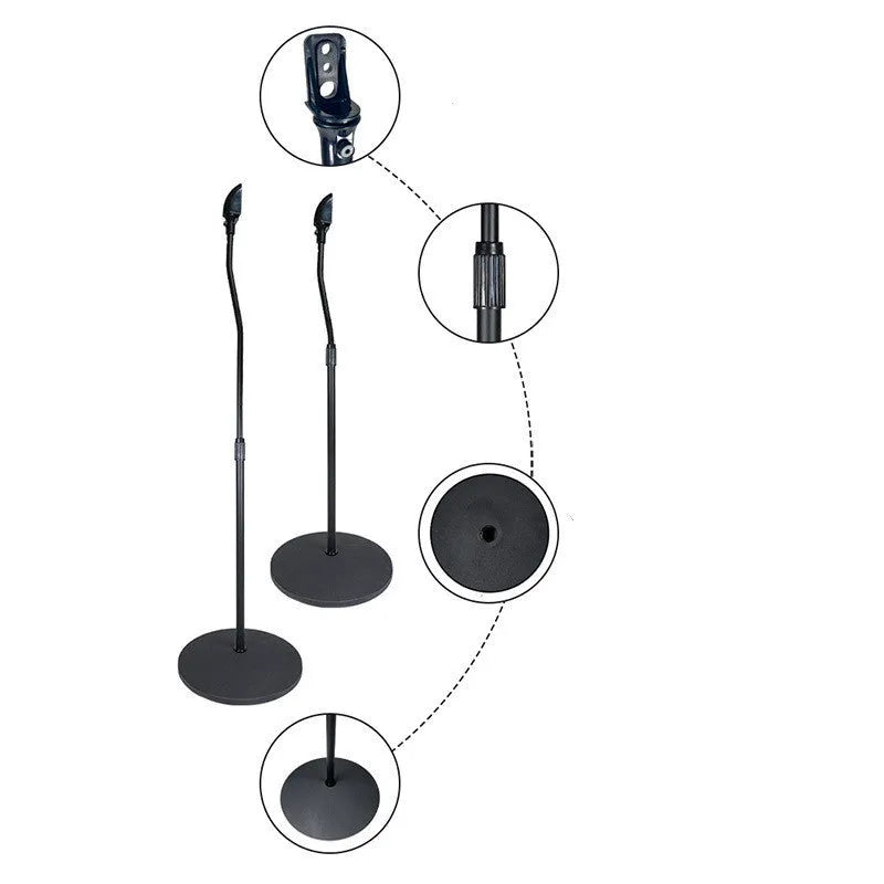 Black tripod speaker stand with universal hanger mount for bookshelf speakers on a wooden floor.