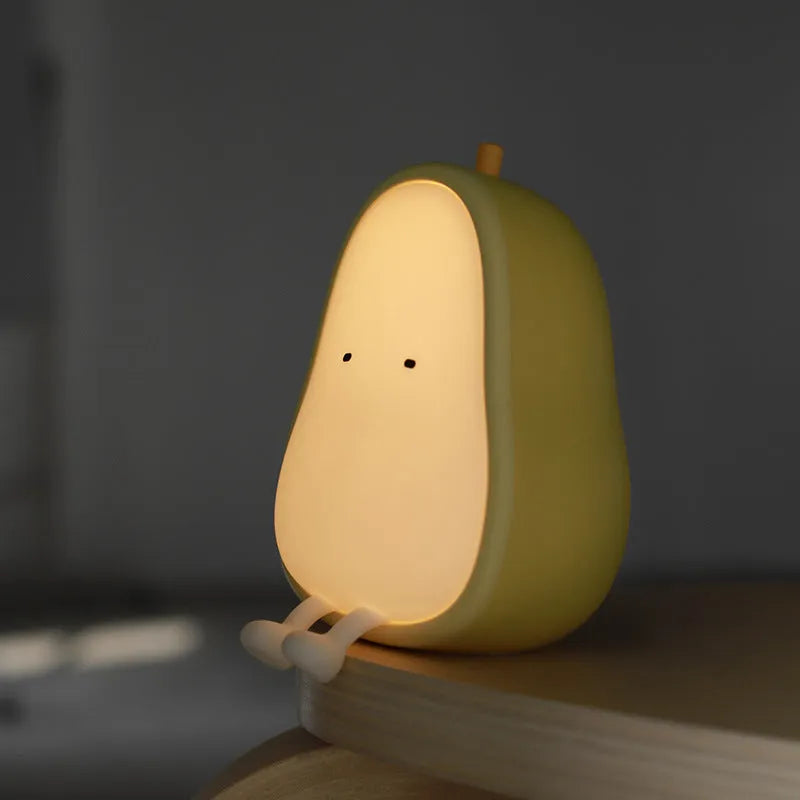 PEAR NIGHT LAMP rechargeable silicone bedside light with warm yellow glow on a surface