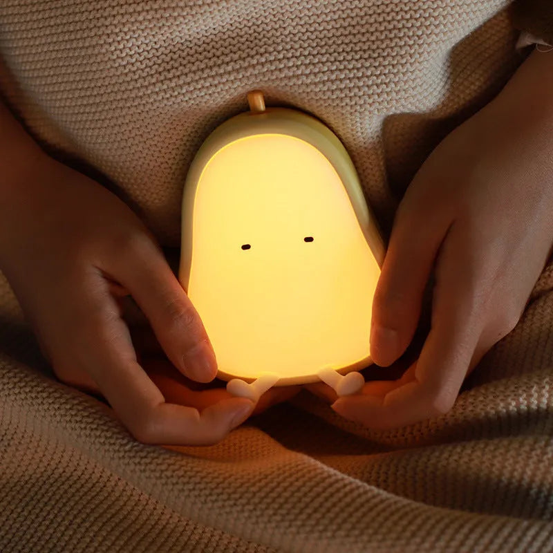 PEAR NIGHT LAMP rechargeable silicone bedside light with warm yellow glow on a surface