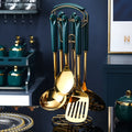 Seven-piece stainless steel kitchen utensil set showing slotted spatula, turner, ladle, serving spoon, and pasta server