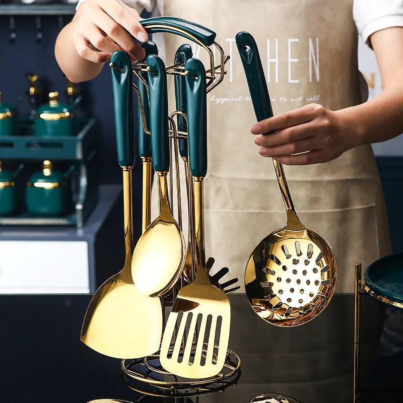 Seven-piece stainless steel kitchen utensil set showing slotted spatula, turner, ladle, serving spoon, and pasta server