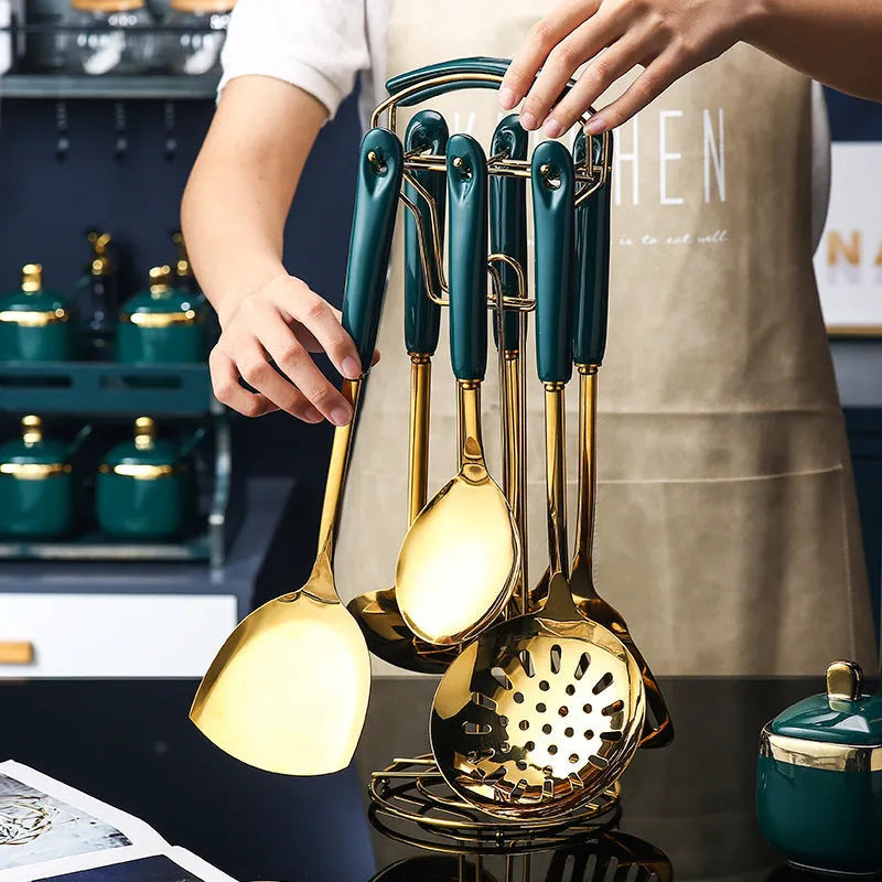 Seven-piece stainless steel kitchen utensil set showing slotted spatula, turner, ladle, serving spoon, and pasta server