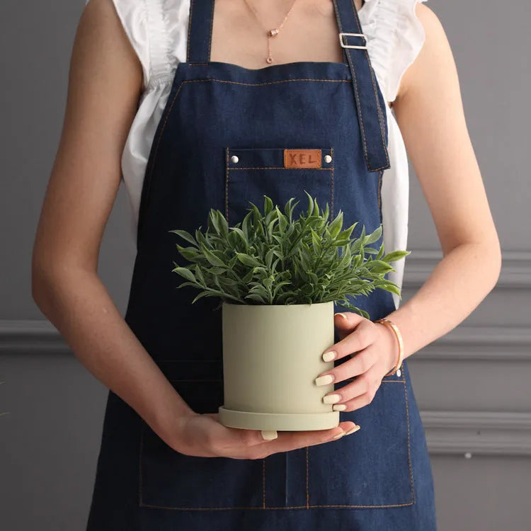 Nordic style cylindrical ceramic cube planter for succulents, shown in a selected colour with visible drainage hole.