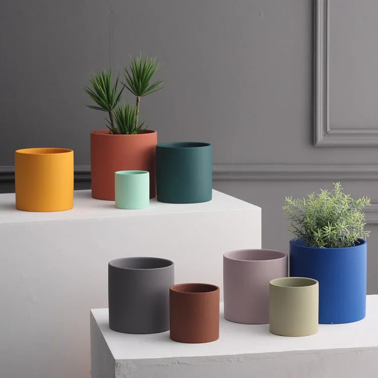 Nordic style cylindrical ceramic cube planter for succulents, shown in a selected colour with visible drainage hole.