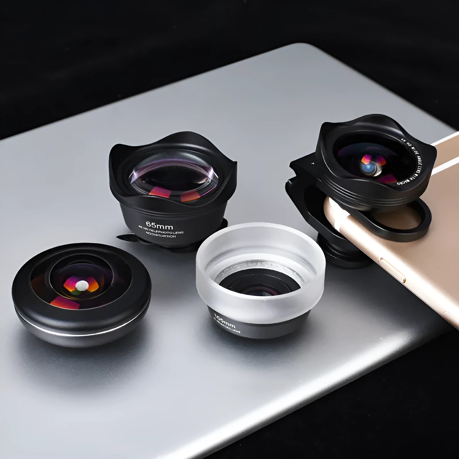 Universal clip-on mobile phone lens kit showing wide-angle, macro, and fisheye lenses for smartphones.