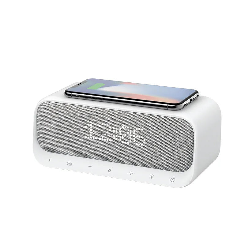 White Anker Soundcore Bluetooth speaker with wireless charging top and digital display.