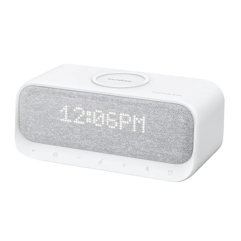 White Anker Soundcore Bluetooth speaker with wireless charging top and digital display.