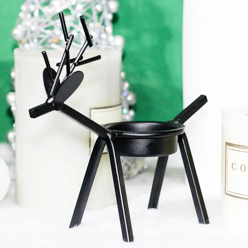 Black iron Christmas candlestick with decorative elk bracket and Santa Claus motifs