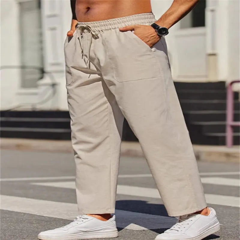 Men's straight-leg linen trousers with an elastic waistband in a solid colour.