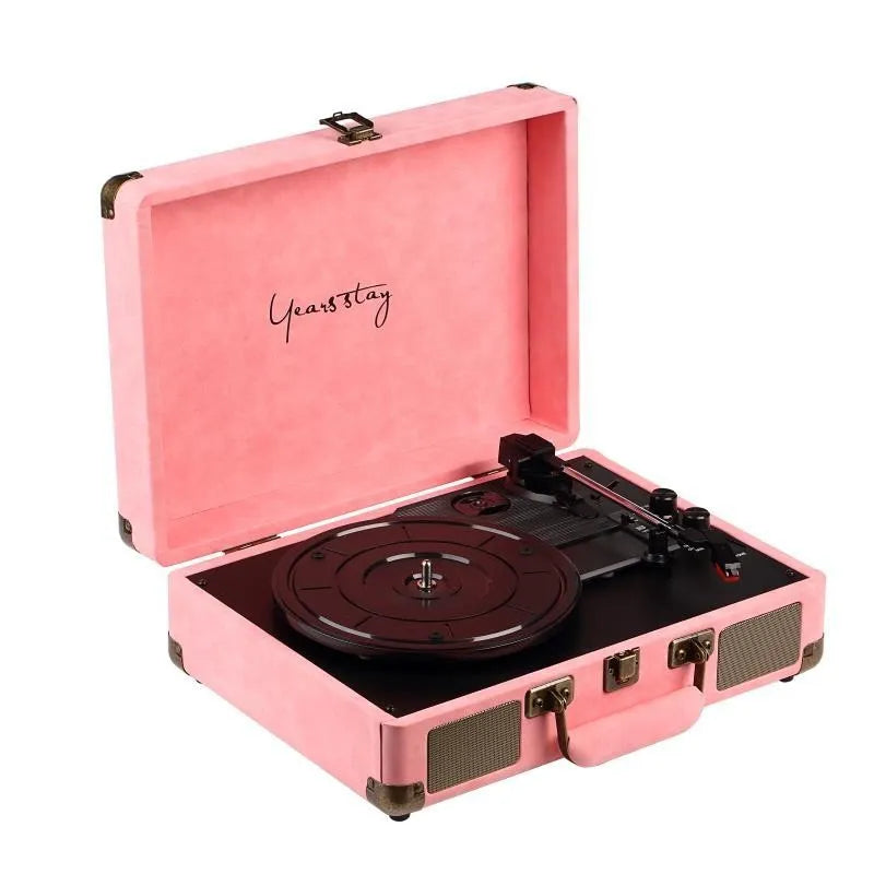 Portable Bluetooth record player in a leather-textured suitcase case, shown in a selection of colours.