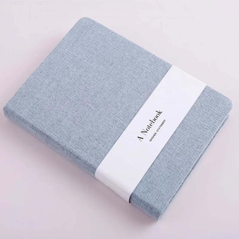 Wire-bound notebook with cloth cover, showing lined pages and blank pages, available in multiple colours and sizes