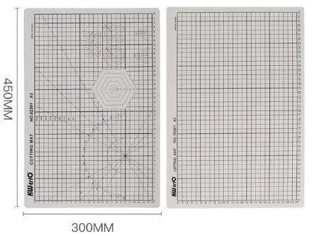 A3 sized green self-healing cutting mat with centimetre grid lines, shown on a desk with a craft knife.