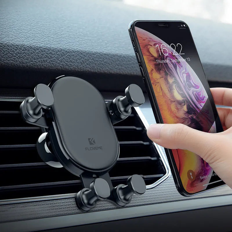 Black car phone holder with 360-degree rotating head on a car dashboard