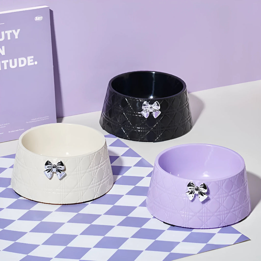 Ceramic pet bowl with diamond pattern and bowknot design in black, purple, and white options