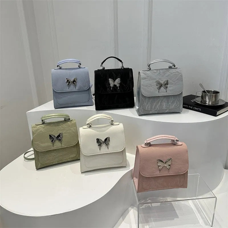 Women's white PU leather hand-carry backpack with bow detail and mobile phone compartment