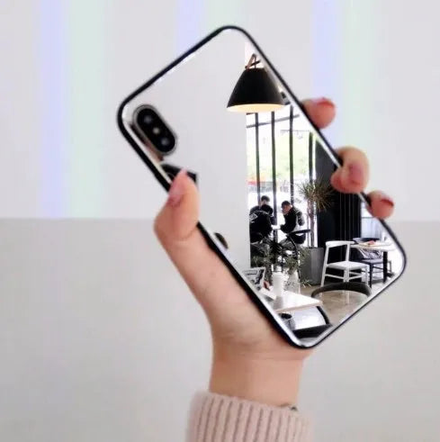 Black iPhone case with a reflective mirror surface on the back, compatible with multiple iPhone models.